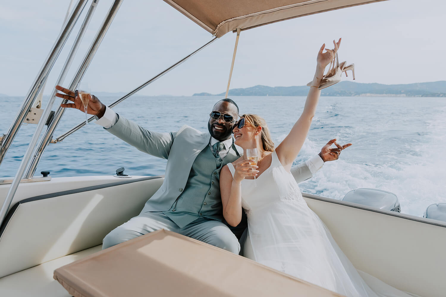 Mariés en séance couple sur un bateau au large du Lavandou, mer calme et ciel doré